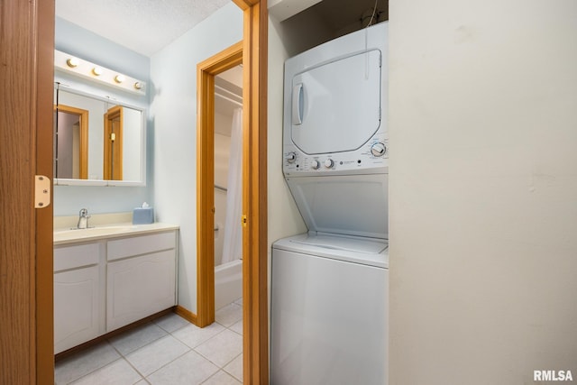 6500 N Allen Rd Unit 62, Peoria, IL 61614 - washroom featuring stacked washer and clothes dryer and light tile patterned floors