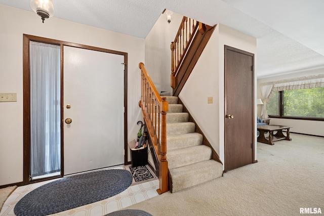 6500 N Allen Rd Unit 62, Peoria, IL 61614 - foyer entrance featuring stairs, light colored carpet, and baseboards