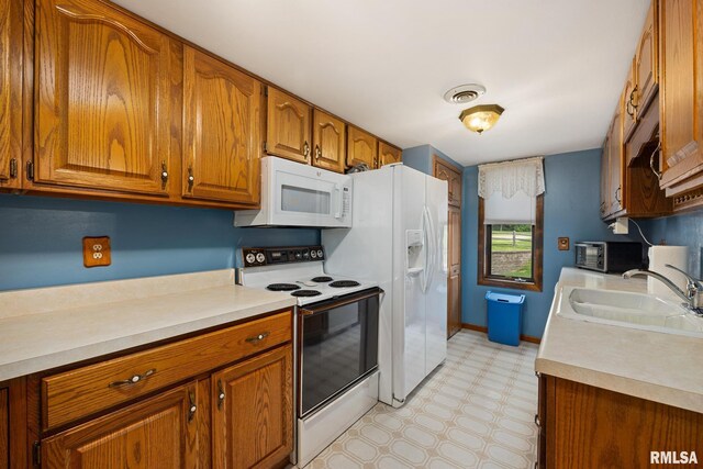 6500 N Allen Rd Unit 62, Peoria, IL 61614 - kitchen featuring white appliances, brown cabinetry, light countertops, and a sink