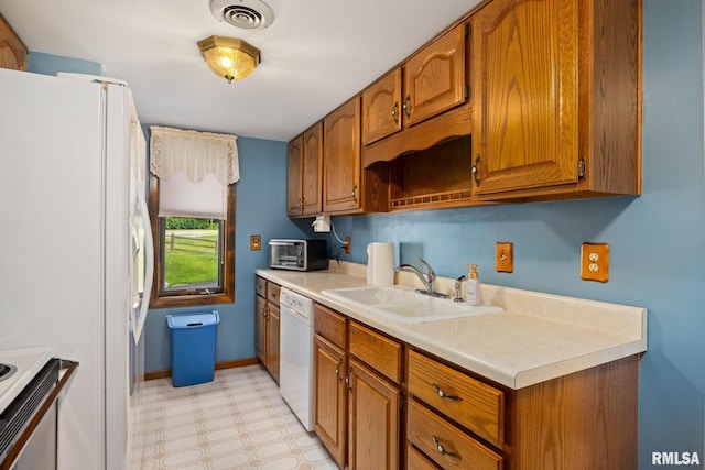 6500 N Allen Rd Unit 62, Peoria, IL 61614 - kitchen with white appliances, a sink, brown cabinets, light countertops, and light floors