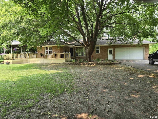 16324 E Cherokee Rd, Cuba, IL 61427 - view of front of property featuring brick siding, driveway, an attached garage, a front lawn, and a porch