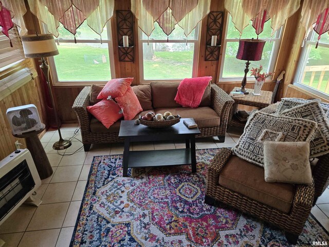 16324 E Cherokee Rd, Cuba, IL 61427 - living area featuring heating unit, wooden walls, plenty of natural light, and light tile patterned floors