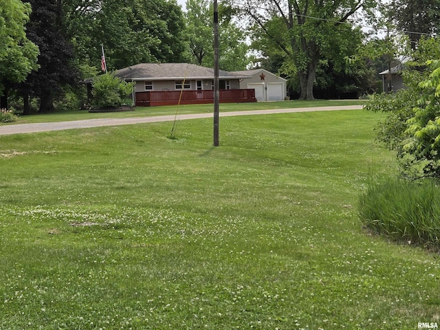 16324 E Cherokee Rd, Cuba, IL 61427 - view of grassy yard featuring a garage and driveway