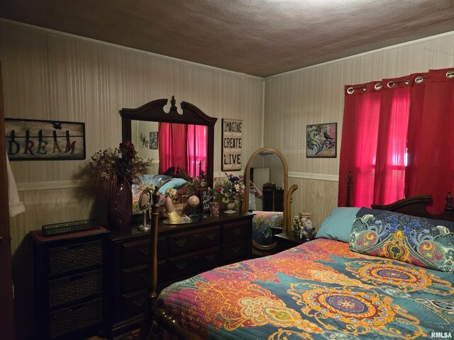 16324 E Cherokee Rd, Cuba, IL 61427 - bedroom featuring a textured ceiling, wood walls, and crown molding
