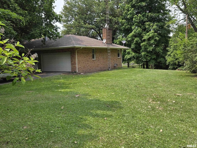 16324 E Cherokee Rd, Cuba, IL 61427 - view of side of property featuring a garage, a chimney, a lawn, brick siding, and asphalt driveway