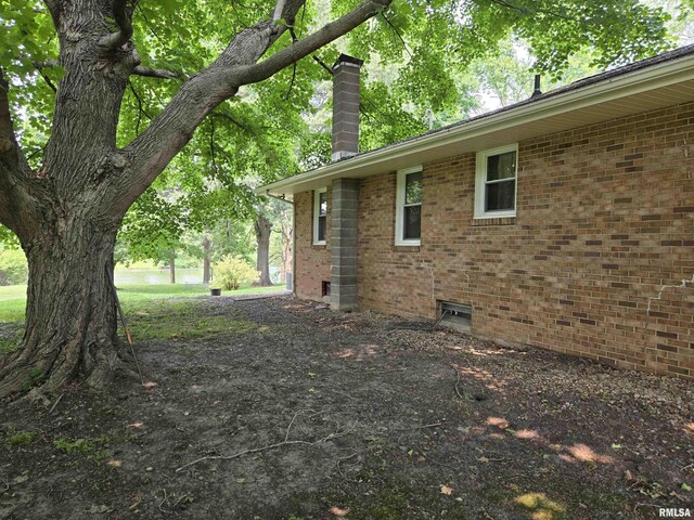 16324 E Cherokee Rd, Cuba, IL 61427 - view of property exterior featuring a chimney and brick siding