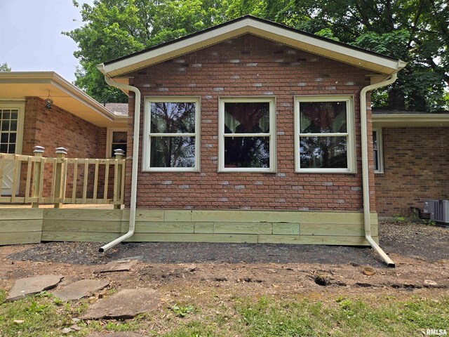 16324 E Cherokee Rd, Cuba, IL 61427 - view of side of home with cooling unit, a deck, and brick siding