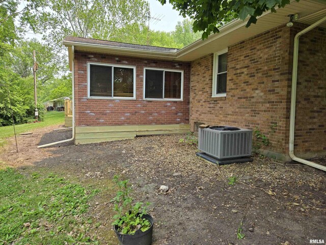 16324 E Cherokee Rd, Cuba, IL 61427 - view of property exterior with central air condition unit and brick siding