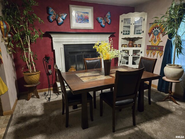 16324 E Cherokee Rd, Cuba, IL 61427 - dining area featuring carpet floors, a glass covered fireplace, and baseboards
