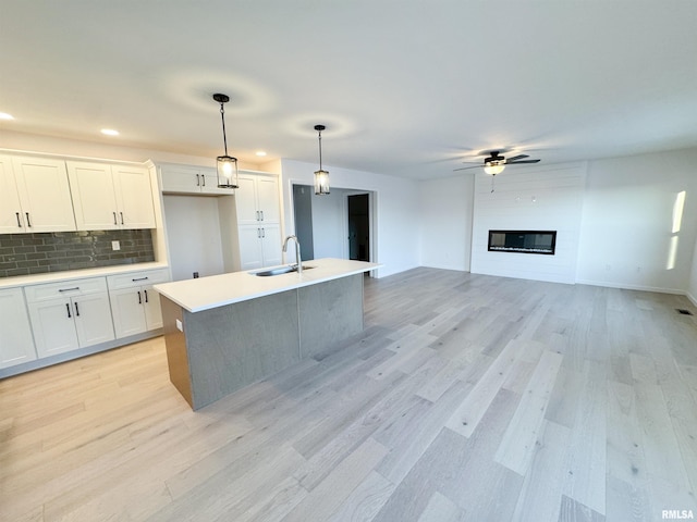 4014 W Fiona Way, Dunlap, IL 61525 - kitchen with light wood-style floors, ceiling fan, tasteful backsplash, white cabinets, and recessed lighting