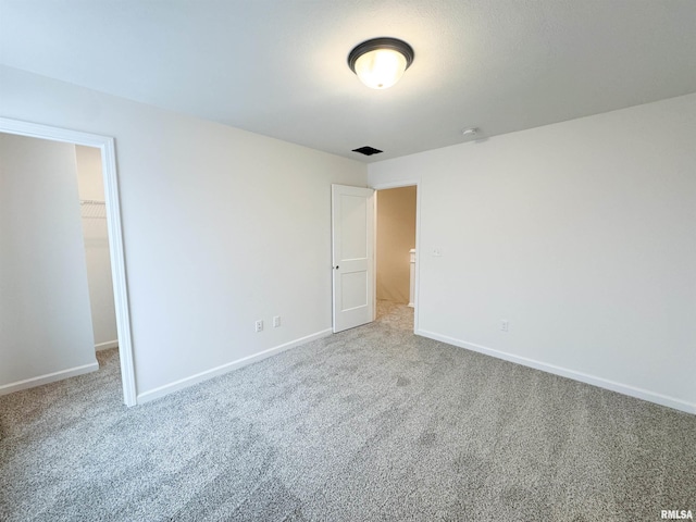 4014 W Fiona Way, Dunlap, IL 61525 - unfurnished bedroom featuring a walk in closet, carpet floors, and a closet