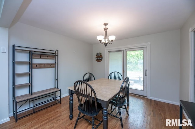 5232 N Merrimac Ave, Peoria, IL 61614 - dining space featuring a chandelier, wood finished floors, and baseboards