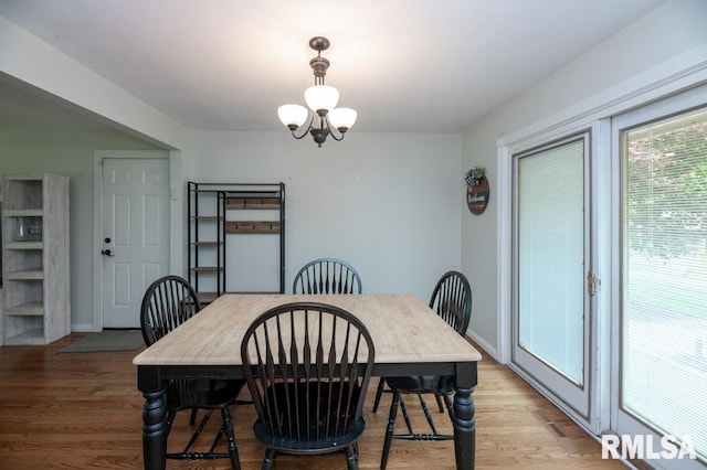 5232 N Merrimac Ave, Peoria, IL 61614 - dining space with light wood finished floors, a chandelier, and baseboards