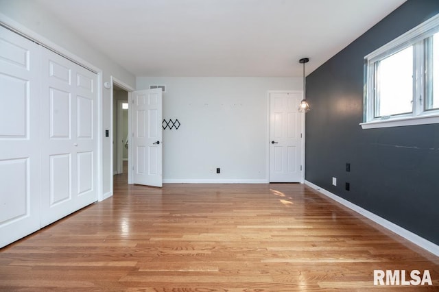 5232 N Merrimac Ave, Peoria, IL 61614 - unfurnished bedroom featuring light wood-type flooring and baseboards