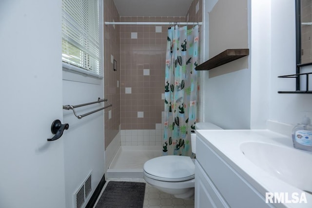 5232 N Merrimac Ave, Peoria, IL 61614 - bathroom with toilet, a stall shower, vanity, and tile patterned flooring