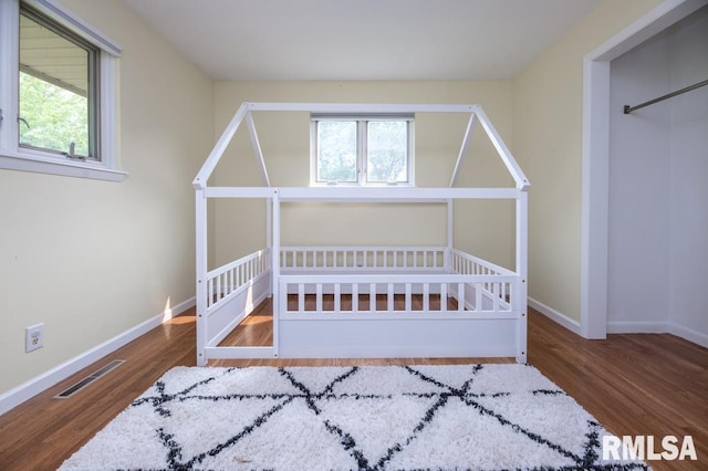 5232 N Merrimac Ave, Peoria, IL 61614 - bedroom with wood finished floors, multiple windows, and baseboards