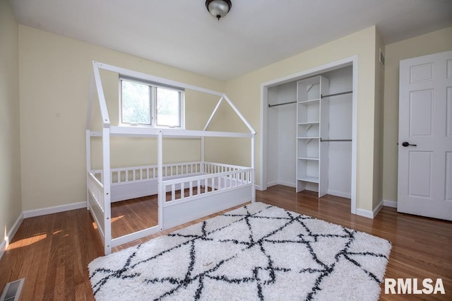 5232 N Merrimac Ave, Peoria, IL 61614 - bedroom featuring a closet, baseboards, and wood finished floors