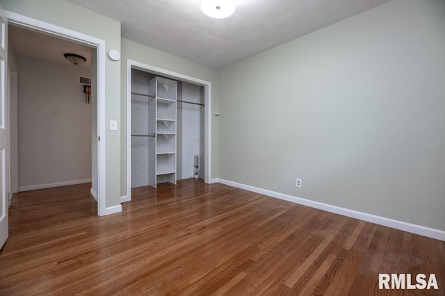 5232 N Merrimac Ave, Peoria, IL 61614 - unfurnished bedroom with wood finished floors, a closet, and baseboards