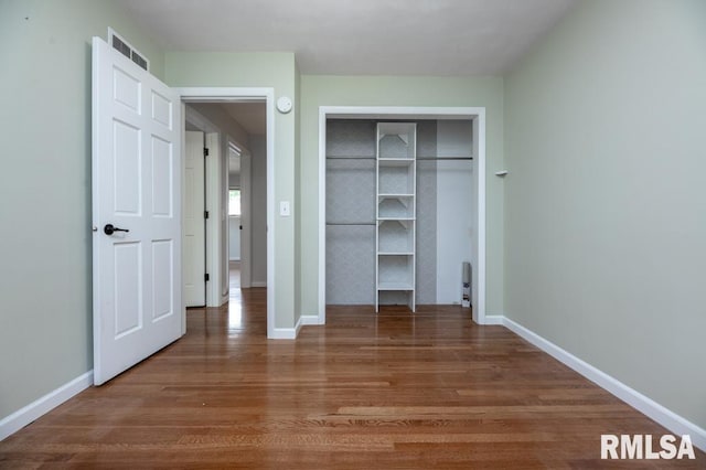 5232 N Merrimac Ave, Peoria, IL 61614 - unfurnished bedroom featuring wood finished floors, baseboards, and a closet