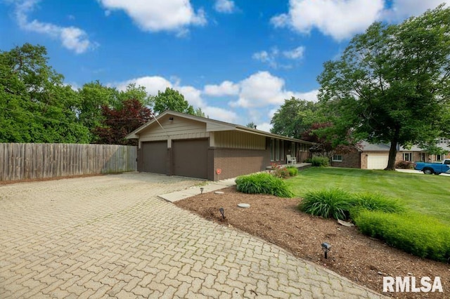 5232 N Merrimac Ave, Peoria, IL 61614 - view of side of property featuring brick siding, decorative driveway, and a garage