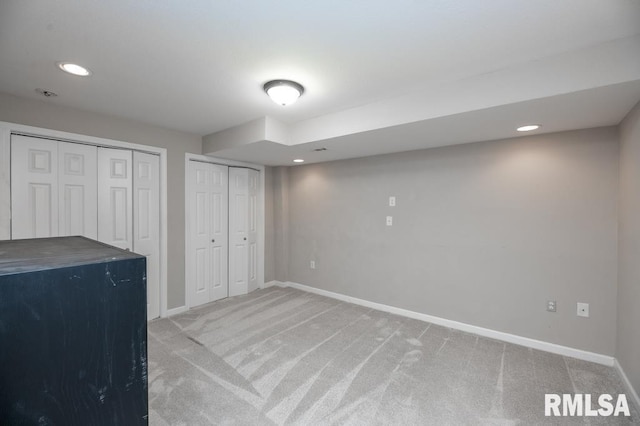 5232 N Merrimac Ave, Peoria, IL 61614 - unfurnished bedroom featuring light colored carpet, baseboards, recessed lighting, and multiple closets