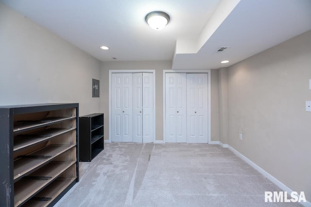 5232 N Merrimac Ave, Peoria, IL 61614 - unfurnished bedroom with light carpet, multiple closets, baseboards, recessed lighting, and electric panel