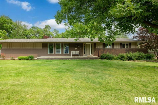 5232 N Merrimac Ave, Peoria, IL 61614 - rear view of house featuring brick siding, covered porch, a yard, and board and batten siding