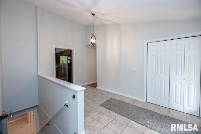 5232 N Merrimac Ave, Peoria, IL 61614 - corridor with light tile patterned floors, an upstairs landing, and baseboards