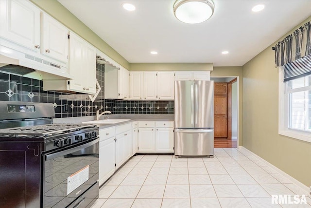 303 W 3rd Ave, Deer Creek, IL 61733 - kitchen featuring freestanding refrigerator, black gas stove, under cabinet range hood, a sink, and tasteful backsplash