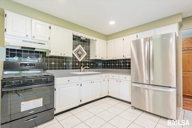 303 W 3rd Ave, Deer Creek, IL 61733 - kitchen featuring freestanding refrigerator, gas stove, under cabinet range hood, a sink, and white cabinets