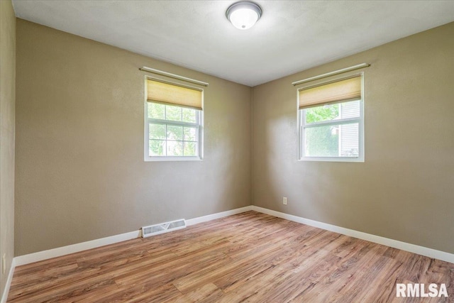 303 W 3rd Ave, Deer Creek, IL 61733 - spare room with healthy amount of natural light, wood finished floors, and baseboards