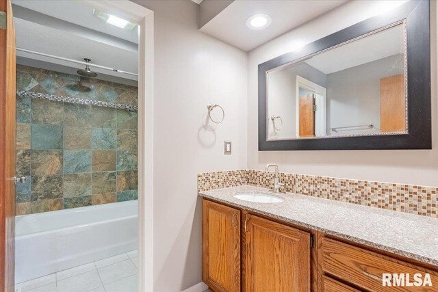 303 W 3rd Ave, Deer Creek, IL 61733 - full bathroom with vanity, tile patterned floors, a combined bath / shower with rainfall shower, and decorative backsplash