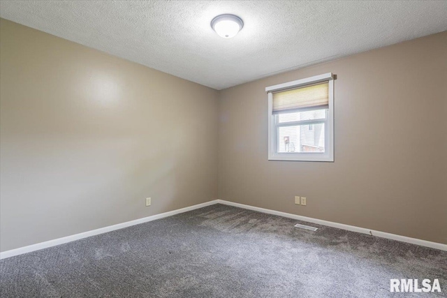 303 W 3rd Ave, Deer Creek, IL 61733 - carpeted empty room featuring baseboards and a textured ceiling
