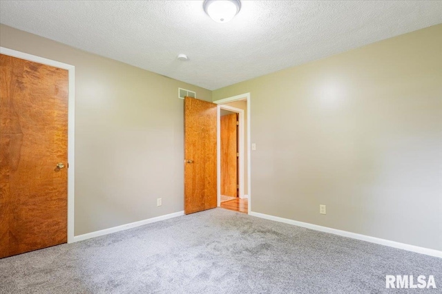 303 W 3rd Ave, Deer Creek, IL 61733 - unfurnished bedroom featuring carpet floors, baseboards, and a textured ceiling