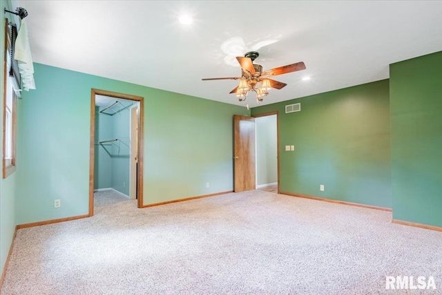 303 W 3rd Ave, Deer Creek, IL 61733 - unfurnished bedroom featuring carpet flooring, baseboards, a walk in closet, a ceiling fan, and recessed lighting