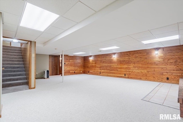 303 W 3rd Ave, Deer Creek, IL 61733 - finished below grade area featuring a drop ceiling, wooden walls, stairway, and carpet flooring