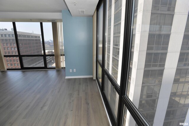 123 SW Jefferson Ave Unit E14A, Peoria, IL 61602 - unfurnished room with wood finished floors and baseboards