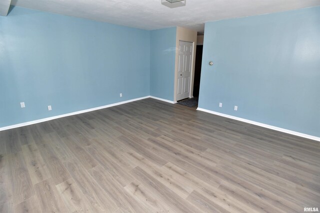 123 SW Jefferson Ave Unit E14A, Peoria, IL 61602 - empty room featuring baseboards and wood finished floors