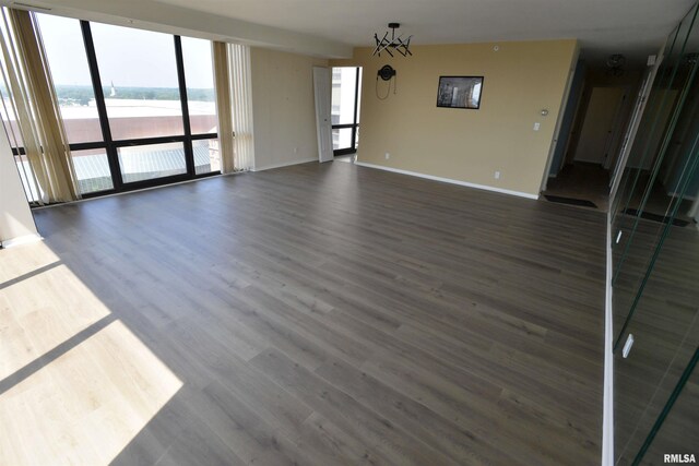 123 SW Jefferson Ave Unit E14A, Peoria, IL 61602 - unfurnished living room featuring baseboards, wood finished floors, and a water view