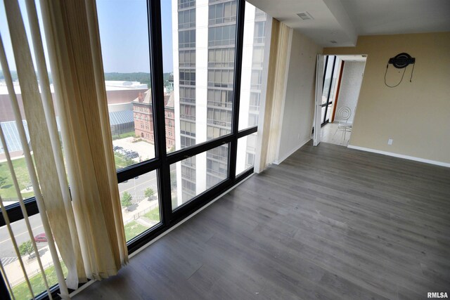 123 SW Jefferson Ave Unit E14A, Peoria, IL 61602 - empty room with wood finished floors and baseboards