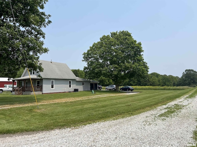 9955 E 750th St, Colchester, IL 62326 - view of side of property with a yard, driveway, and a porch