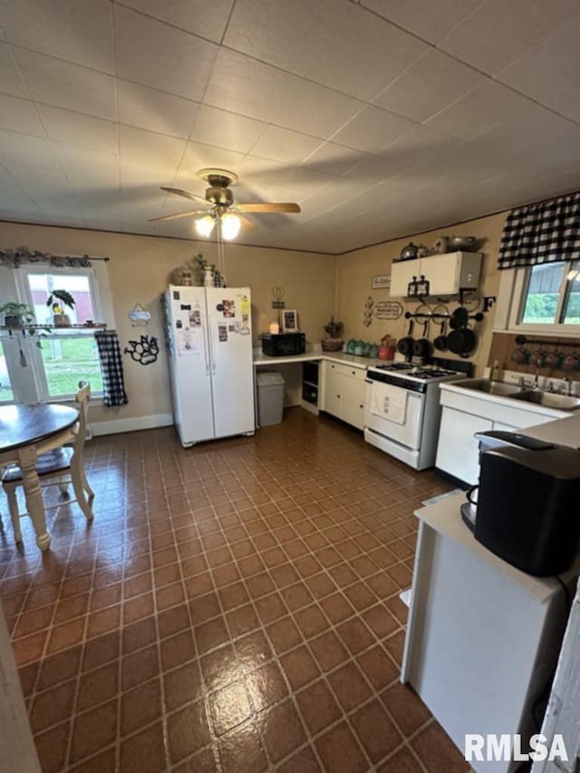 9955 E 750th St, Colchester, IL 62326 - kitchen featuring white appliances, healthy amount of natural light, ceiling fan, and white cabinetry