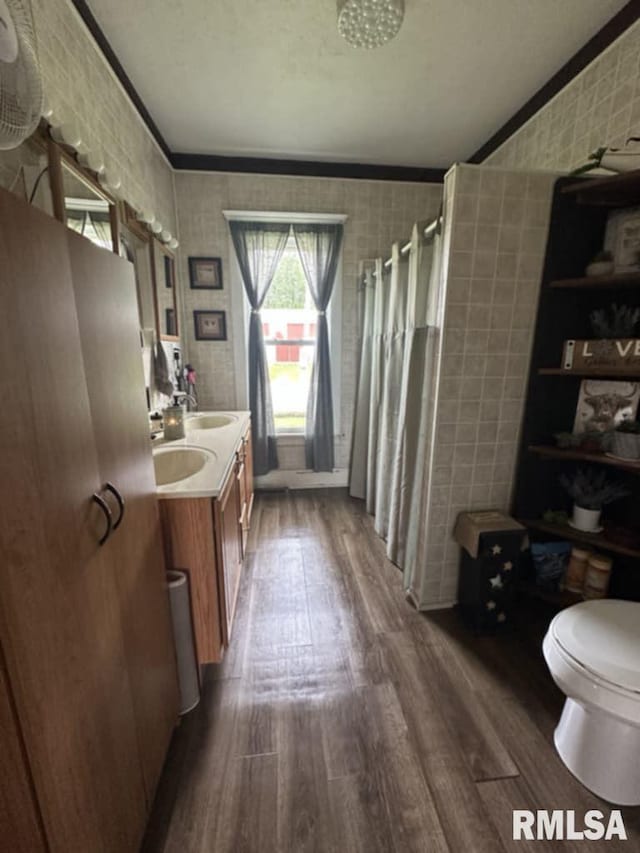 9955 E 750th St, Colchester, IL 62326 - bathroom with wood finished floors, double vanity, curtained shower, ornamental molding, and wallpapered walls