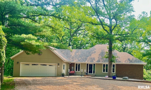 283 Old Germantown Rd, East Peoria, IL 61611 - ranch-style house featuring dirt driveway, an attached garage, covered porch, and roof with shingles