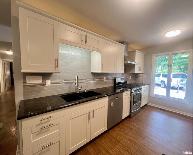 283 Old Germantown Rd, East Peoria, IL 61611 - kitchen featuring appliances with stainless steel finishes, wall chimney range hood, a sink, and decorative backsplash