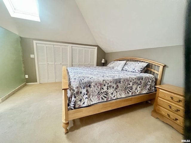 283 Old Germantown Rd, East Peoria, IL 61611 - bedroom with light carpet, vaulted ceiling, a skylight, and baseboards