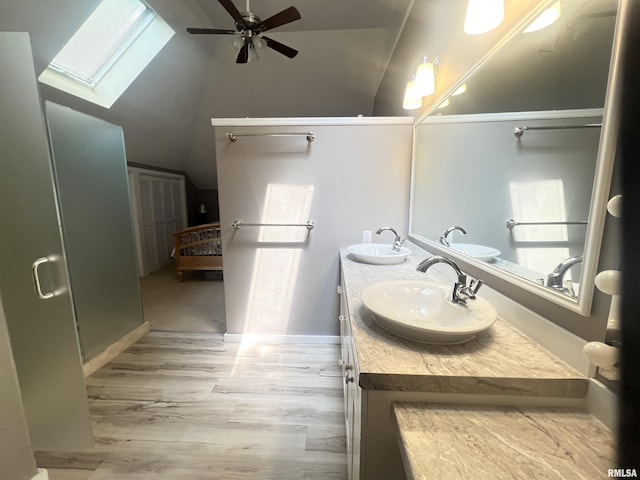 283 Old Germantown Rd, East Peoria, IL 61611 - bathroom featuring a skylight, ceiling fan, wood finished floors, double vanity, and lofted ceiling