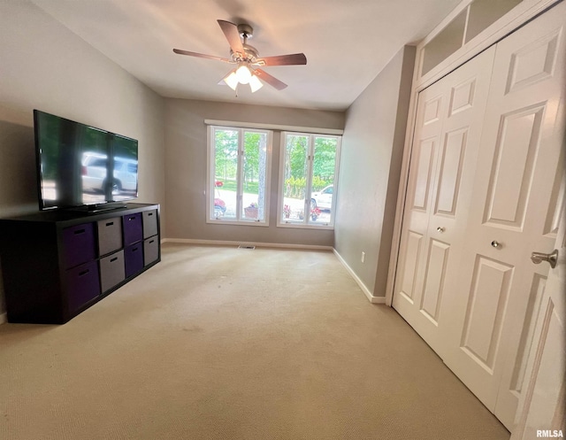 283 Old Germantown Rd, East Peoria, IL 61611 - unfurnished living room featuring baseboards, ceiling fan, and light colored carpet