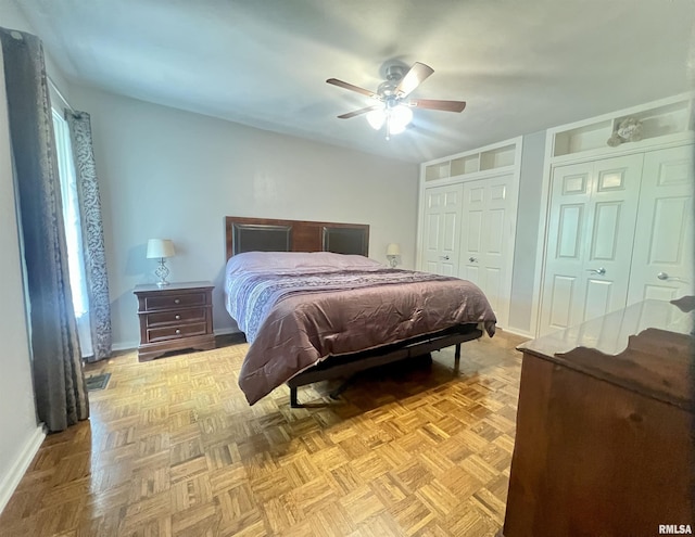 283 Old Germantown Rd, East Peoria, IL 61611 - bedroom with baseboards, a ceiling fan, and two closets