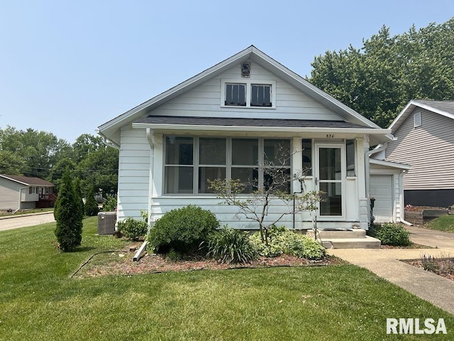 836 S Johnson St, Macomb, IL 61455 - view of front of property featuring a front lawn, a garage, central air condition unit, and a shingled roof